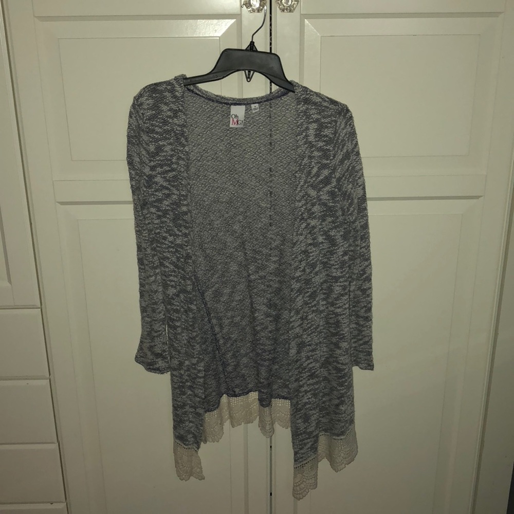 A cute grey light sweater with lace at bottom.
